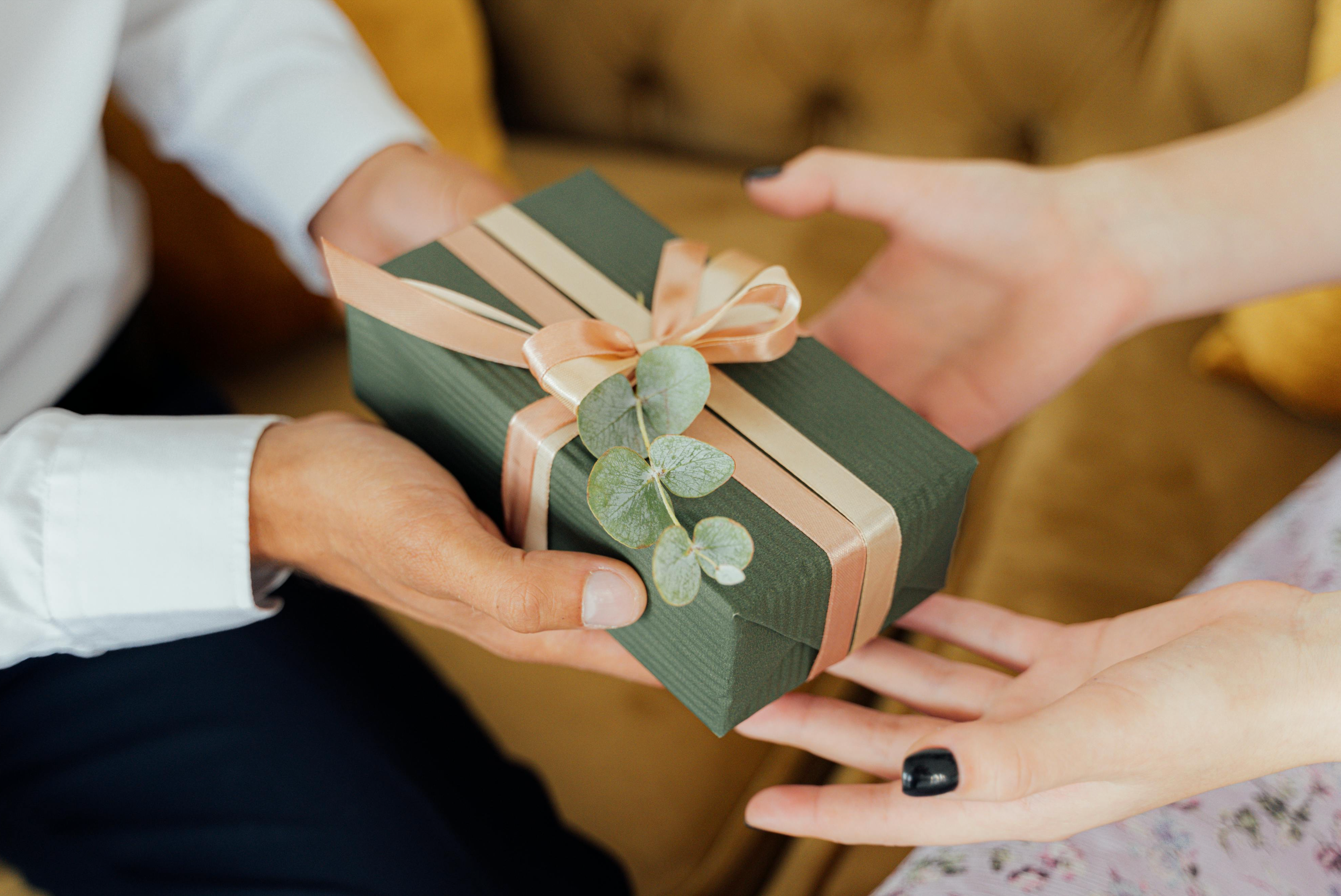 A neatly wrapped gift in eco-friendly green wrapping paper, showcasing sustainable and zero-waste packaging.